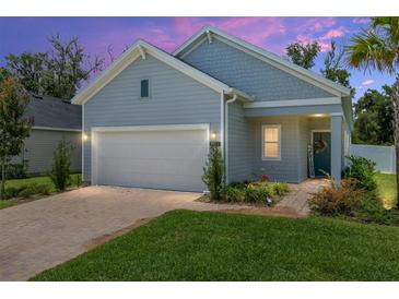 Charming one-story home boasts a brick driveway, two-car garage, and lovely landscaping, perfect for curb appeal at 1814 Nw 44 Court Rd, Ocala, FL 34482