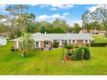 Charming one-story home with a well-manicured lawn, mature trees and tasteful landscaping at 616 Se 40Th Ave, Ocala, FL 34471