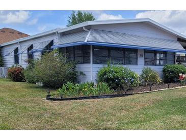 Charming single-story home with a well-maintained lawn and tidy landscaping at 741 Truman Ave, Lady Lake, FL 32159