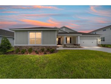 Charming one-story home with stone accents and a well-manicured lawn at 7513 Sw 56Th Pl, Ocala, FL 34474