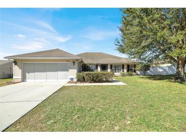 Charming single-story home with a well-maintained lawn and attached two-car garage at 9952 Sw 58Th Ave, Ocala, FL 34476