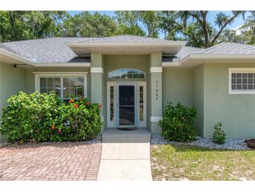 Charming single-story home with well-manicured landscaping and a welcoming front entrance at 11645 Mallard Ct, Dunnellon, FL 34432