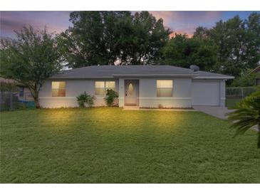 Charming single-story home with a well-maintained lawn and inviting front entrance at dusk at 18 Banyan Pass, Ocala, FL 34472