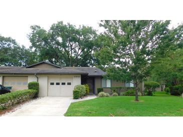 Charming single-story home with lush landscaping, a driveway, and an attached one car garage at 3856 Ne 17Th Street Cir, Ocala, FL 34470