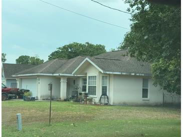 Cozy single-story home with a well-maintained lawn and attached garage at 22 Banyan Trak, Ocala, FL 34472