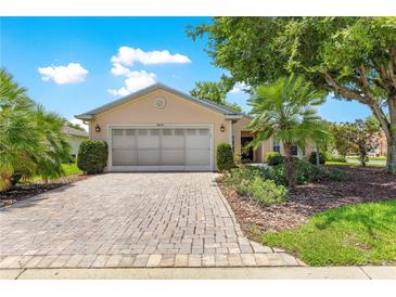 Charming single-story home with a brick driveway and lush, manicured landscaping at 8034 Sw 81St Loop, Ocala, FL 34476