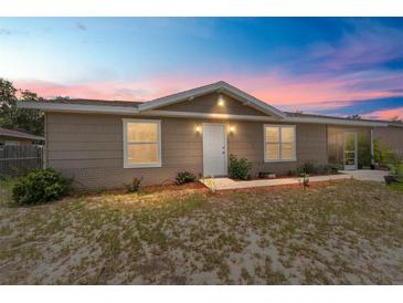 Charming single-story home featuring neutral siding, brick accents, white trim and front door, and well-maintained landscaping at 8940 Se 87Th Ter, Ocala, FL 34472