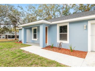 Charming single-story home with blue exterior and inviting front porch, enhancing curb appeal at 15369 Sw 38Th Pl, Ocala, FL 34481