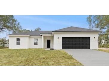 Charming single-story home with a modern design, neutral colors, and an attached two-car garage at 1686 Sw 168Th Loop, Ocala, FL 34473