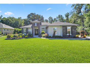 Beautifully landscaped front yard and modern exterior elevation on a single-story home at 3993 Se 10Th Ave, Ocala, FL 34480