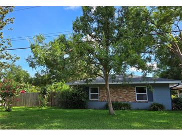 Charming single story home with brick accents, mature trees, and a well-maintained lawn at 3709 Ne 4Th St, Ocala, FL 34470