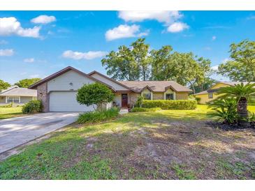 Charming single-story home with a well-maintained front yard and inviting curb appeal with a garage and lovely landscaping at 5581 Se 35Th St, Ocala, FL 34480
