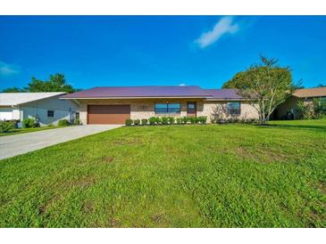 Charming brick single-story home with well-manicured lawn and a durable metal roof at 6142 Se 37Th Ter, Ocala, FL 34480