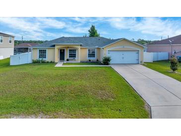 Charming single-story home with a well-maintained lawn and attached two-car garage at 7327 Sw 129Th Ln, Ocala, FL 34473