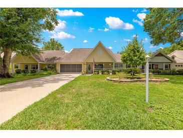 Charming one-story home with lush landscaping, well-manicured lawn, and a welcoming front porch at 8351 Sw 93Rd Ln # C, Ocala, FL 34481