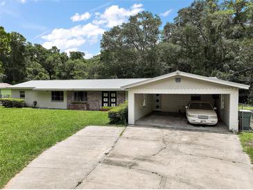 Charming one-story home featuring brick accents and a covered carport at 2155 Nw 27Th Ave, Ocala, FL 34475