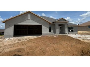 Charming single-Gathering home featuring an attached two-car garage and an inviting front entrance at 4340 Nw 1St Ave, Ocala, FL 34475