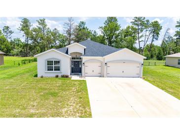 Charming single-story home featuring a two-car garage and well-maintained landscaping at 5239 Sw 114Th Street Rd, Ocala, FL 34476