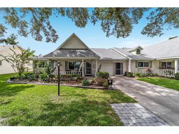 Charming home featuring meticulous landscaping, a neutral facade, and an attached one car garage at 8841 Sw 91St St # A, Ocala, FL 34481