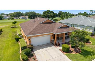 Beautiful single Gathering home with a well maintained lawn and a two car garage at 9236 Sw 91St Court Rd, Ocala, FL 34481