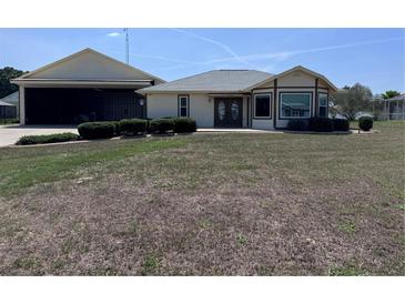 Charming single-story home featuring a unique attached aircraft hangar at 9700 Se 72Nd Ave, Ocala, FL 34472