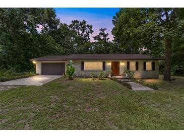 Charming single-story home featuring a well-manicured lawn, neutral paint, and a two-car garage at 19130 Nw 60Th Ave, Reddick, FL 32686
