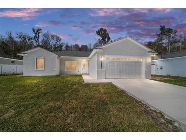 Charming single-story home featuring a well-manicured lawn and an attached two-car garage at 13741 Sw 81St Cir, Ocala, FL 34473
