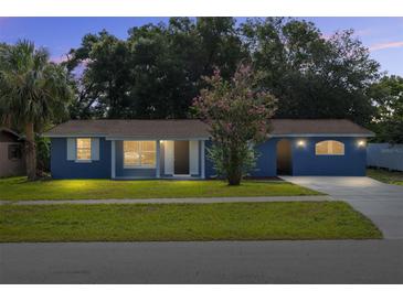 Charming single-story home with blue exterior, well-maintained lawn, and mature landscaping at 14761 Sw 35Th Terrace Rd, Ocala, FL 34473