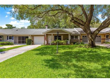 Inviting one-story home with a well-manicured lawn and mature oak tree at 8850 Sw 97Th St # C, Ocala, FL 34481