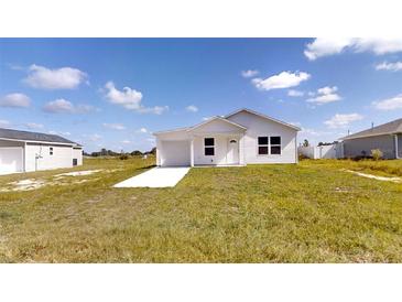 Charming single-story home featuring a well-maintained lawn, attached garage, and inviting curb appeal at 2740 Sw 147Th Ter, Ocala, FL 34481