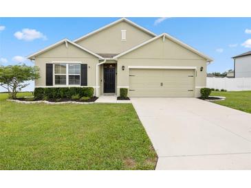 Charming single-story home with a well-manicured lawn, inviting entrance, and two car garage at 2984 Ne 43Rd Rd, Ocala, FL 34470