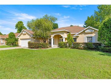 Charming single-story home featuring a well-manicured lawn and mature landscaping at 4555 Nw 6Th Cir, Ocala, FL 34475