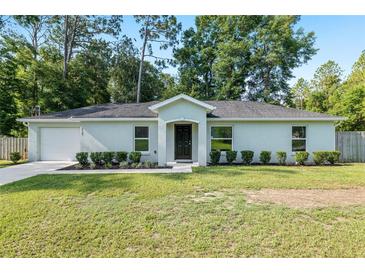 Charming single-story home with a well-manicured lawn and fresh landscaping at 5740 Nw 61St St, Ocala, FL 34482