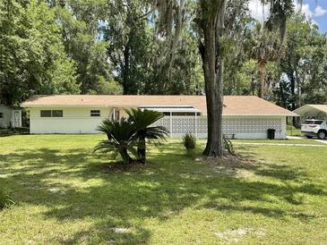 Charming one-story home with a well-maintained lawn and decorative cinder block privacy wall at 1523 Se 80Th St, Ocala, FL 34480