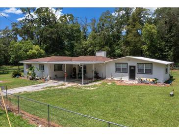 Charming single-story home with a spacious front yard and convenient covered carport at 2340 Ne 14Th Ave, Ocala, FL 34470