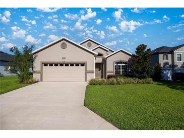 Well-maintained one-story home with a two-car garage, manicured lawn and beautiful landscaping at 3948 Se 4Th Ter, Ocala, FL 34480