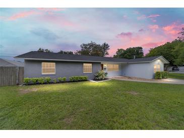 Charming one-story home with a well-manicured lawn and lush landscaping for a picturesque curb appeal at 5500 Se 2Nd Pl, Ocala, FL 34480