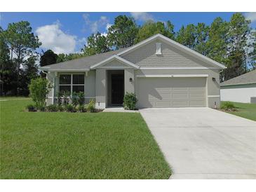 Charming one-story home with a well-manicured lawn and inviting curb appeal at 80 Hickory Course Loop, Ocala, FL 34472