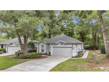 Charming one-story home with a well-manicured lawn and mature trees creating a serene curb appeal at 8775 Sw 192 Ct, Dunnellon, FL 34432