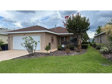 Charming single-story home featuring a well-manicured lawn and delightful landscaping at 9047 Sw 102Nd Cir, Ocala, FL 34481
