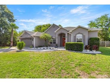 Charming single-story home with lush lawn and mature landscaping, perfect for curb appeal at 2418 Se 22Nd Pl, Ocala, FL 34471