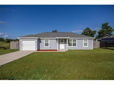 Charming one-story home with a well-manicured lawn and a single-car garage at 3645 Sw 151St Ct, Ocala, FL 34481