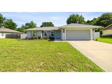 Charming single-story home with well-maintained lawn and a two-car garage at 4325 Se 60Th St, Ocala, FL 34480