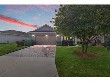 Charming single-story home with a brick-paved driveway and well-maintained lawn at 4970 Nw 35Th Lane Rd, Ocala, FL 34482