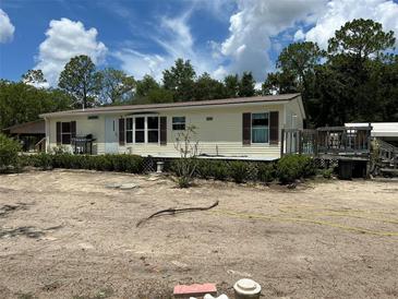 Inviting single-story home with a well-maintained exterior, charming shutters, and a lush green surroundings at 5862 Sw 160Th Ct, Ocala, FL 34481