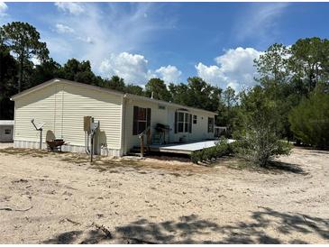 Mobile home featuring a back deck and spacious, sandy yard at 5862 Sw 160Th Ct, Ocala, FL 34481