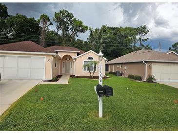 Charming home featuring a well-manicured lawn and lovely curb appeal at 11298 Sw 73Rd Cir, Ocala, FL 34476