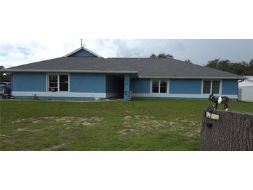 Charming single-story home with blue exterior, well-maintained lawn, and classic windows at 12524 Sw 109Th Pl, Dunnellon, FL 34432