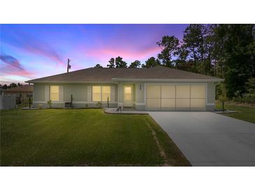 Charming single-story home with well-manicured lawn and two-car garage at 458 Marion Oaks Trail Trl, Ocala, FL 34473