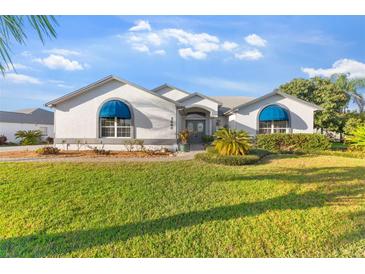 Charming single-story home features a well-manicured lawn and a welcoming front entrance with beautiful awnings at 5660 Sandpipers Dr, Lakeland, FL 33809